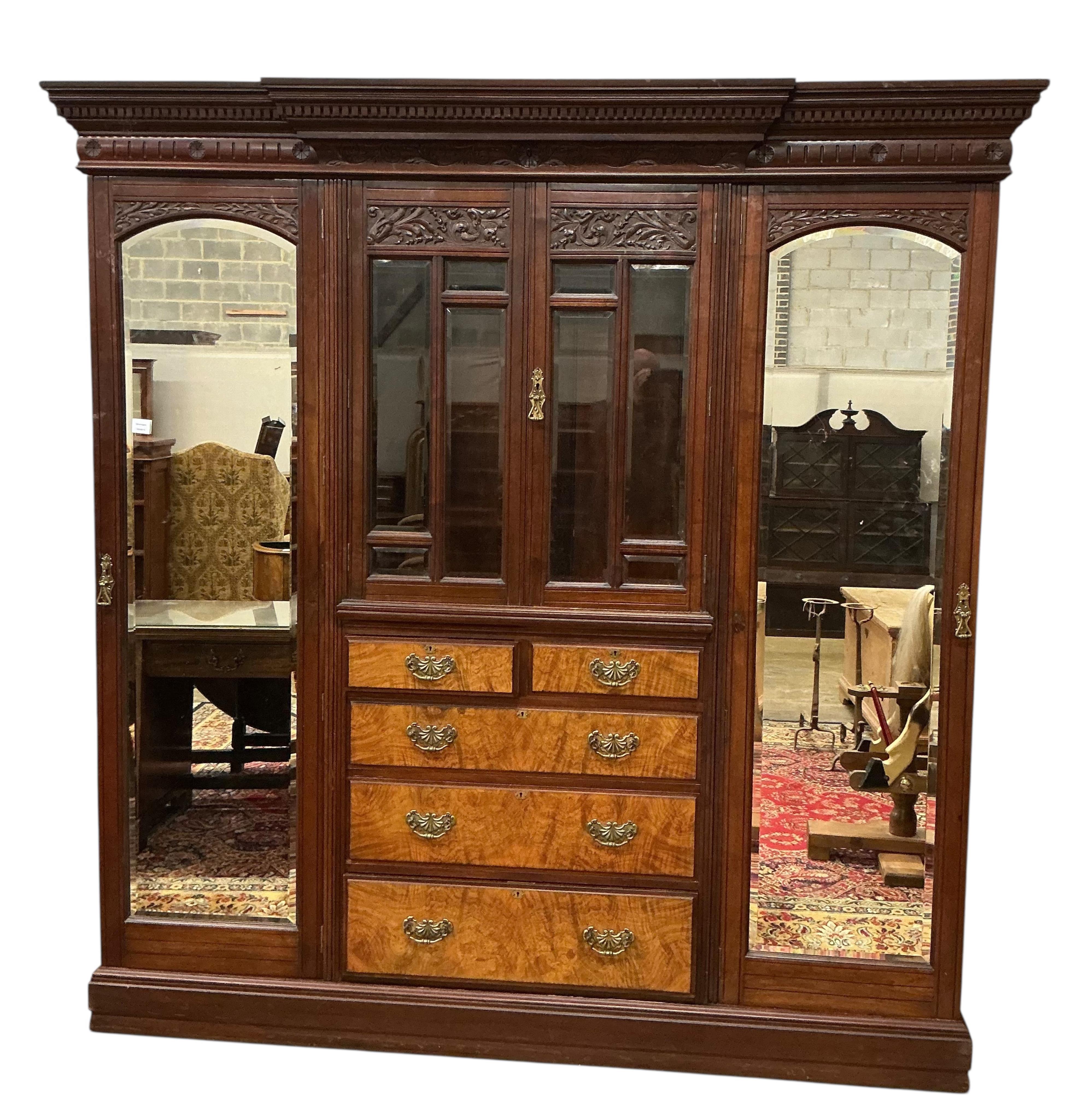 A late Victorian carved mahogany mirrored wardrobe, width 208cm, depth 60cm, height 218cm